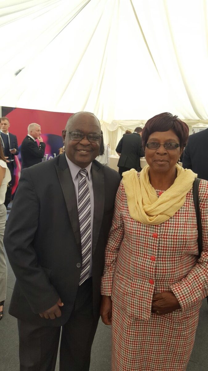 A man and a woman smiling together at an outdoor event